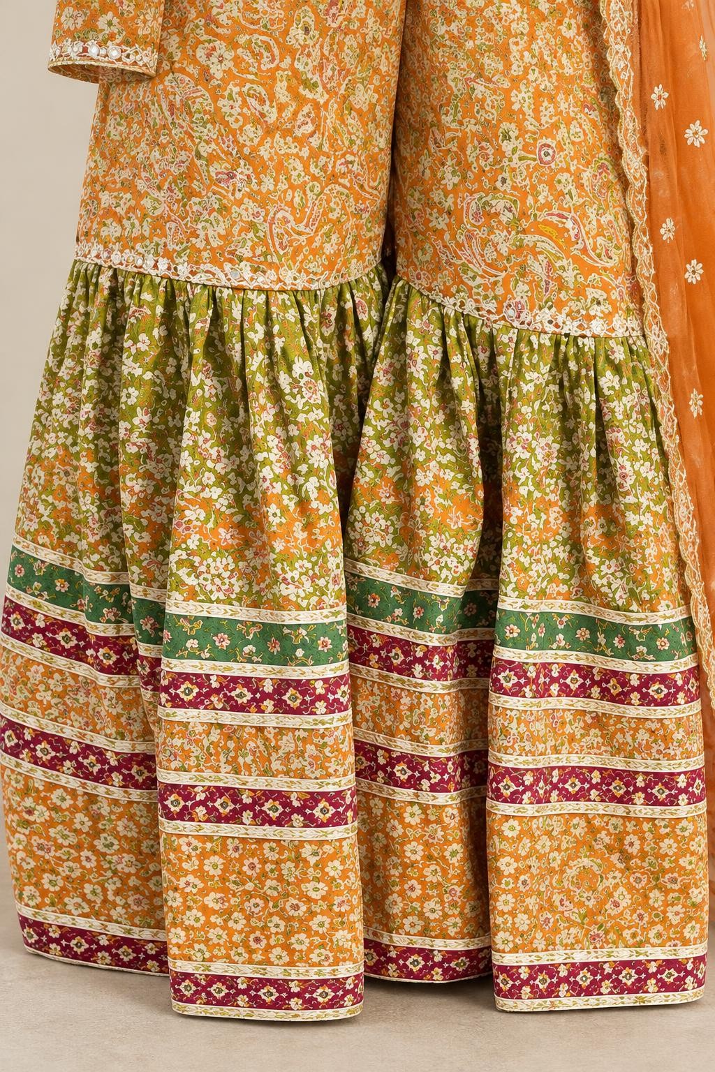 The printed garara with its gathered, striped frill below the knee