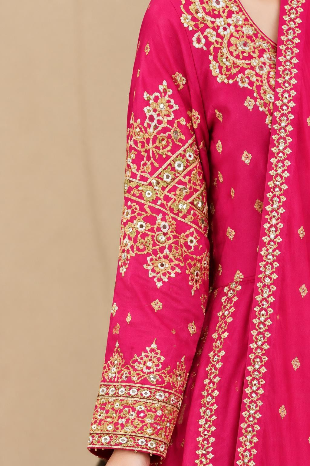 Close-up of the embroidered sleeve and front panel of the pink maxi