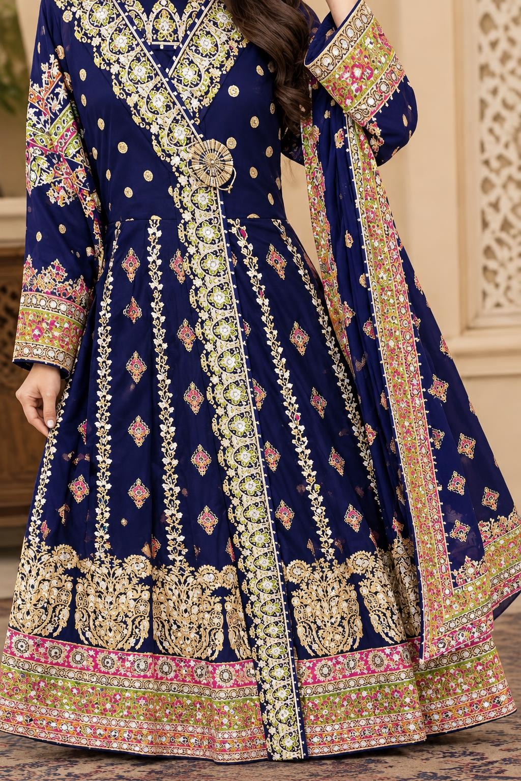 The plum maxi's embroidered front band, waist medallion and hem border