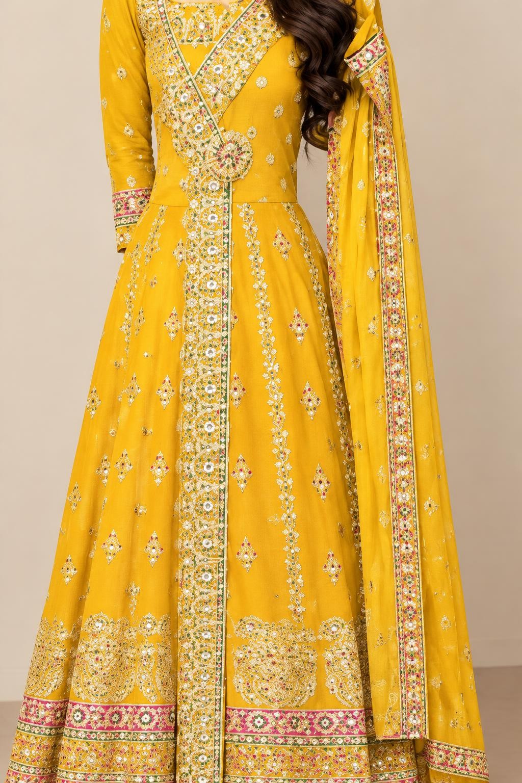 Close-up of the yellow maxi's embroidered front band and pink-and-gold hem border